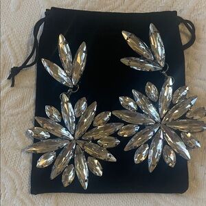 Extremely large costume earrings.